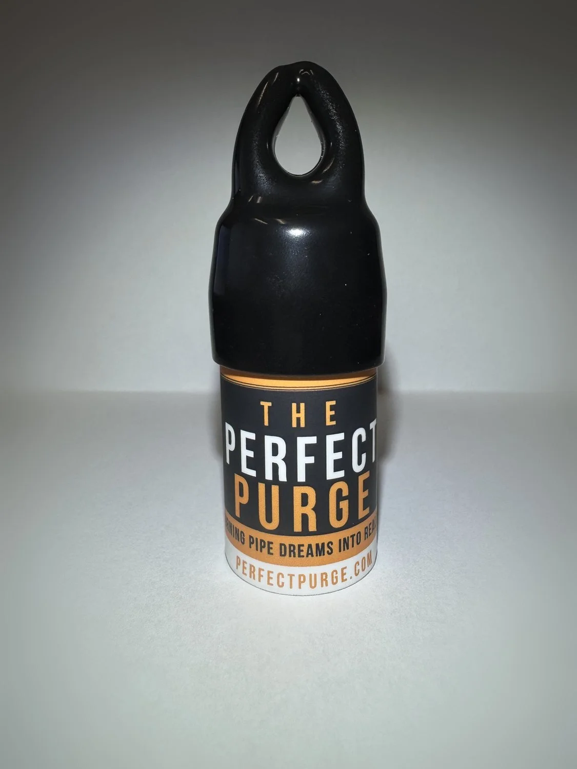 The Perfect Purge in its retail packaging: clear tube with black vinyl hanger cap and branded wrap label.