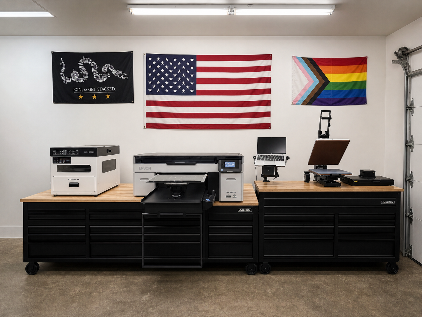 Sound & Steel production line with powder shaker, garment printer, heat press, and flags