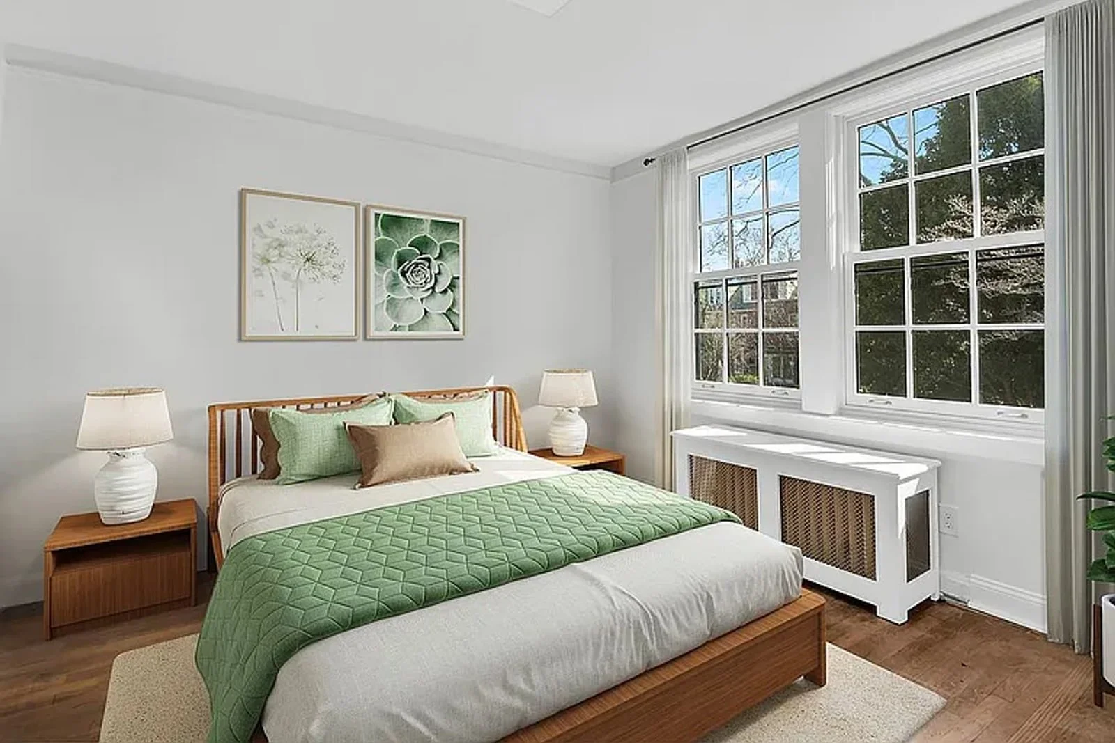 Sunlit bedroom framed by mature trees