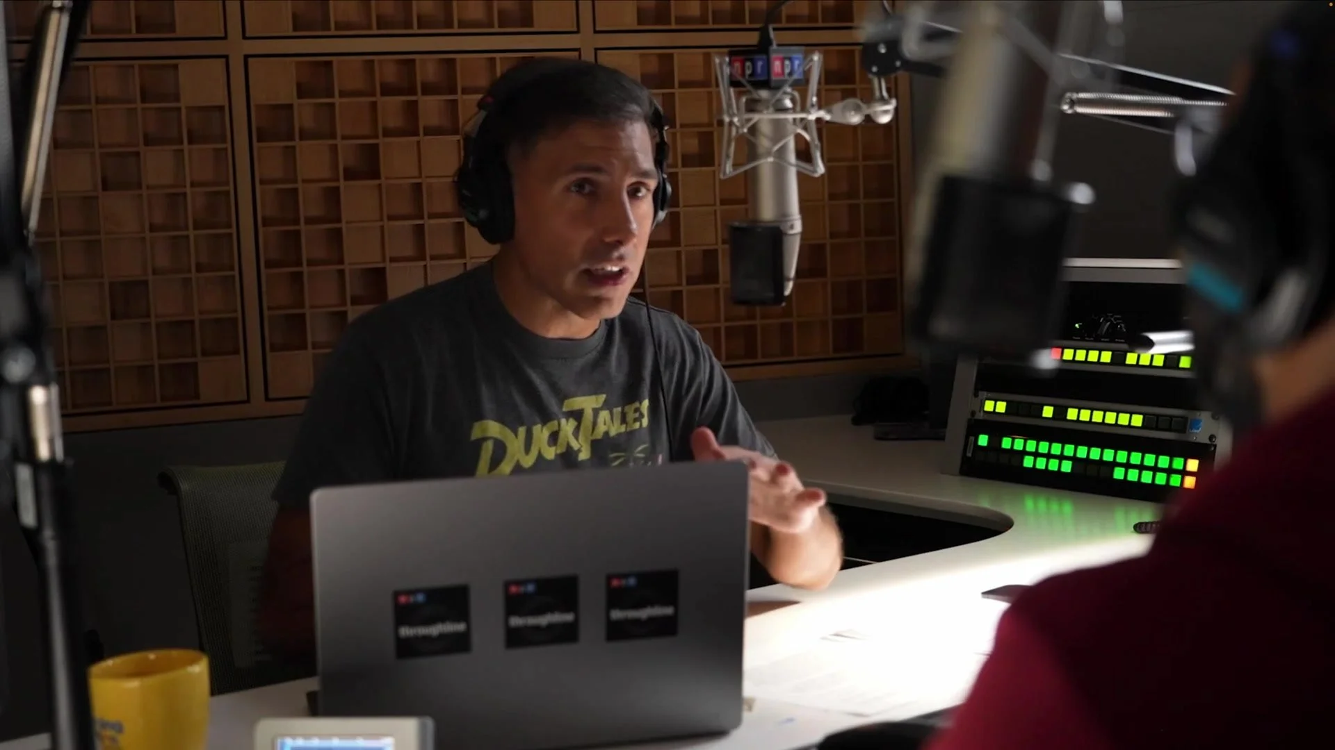 Ramtin Arablouei in conversation at an NPR studio microphone, wearing headphones