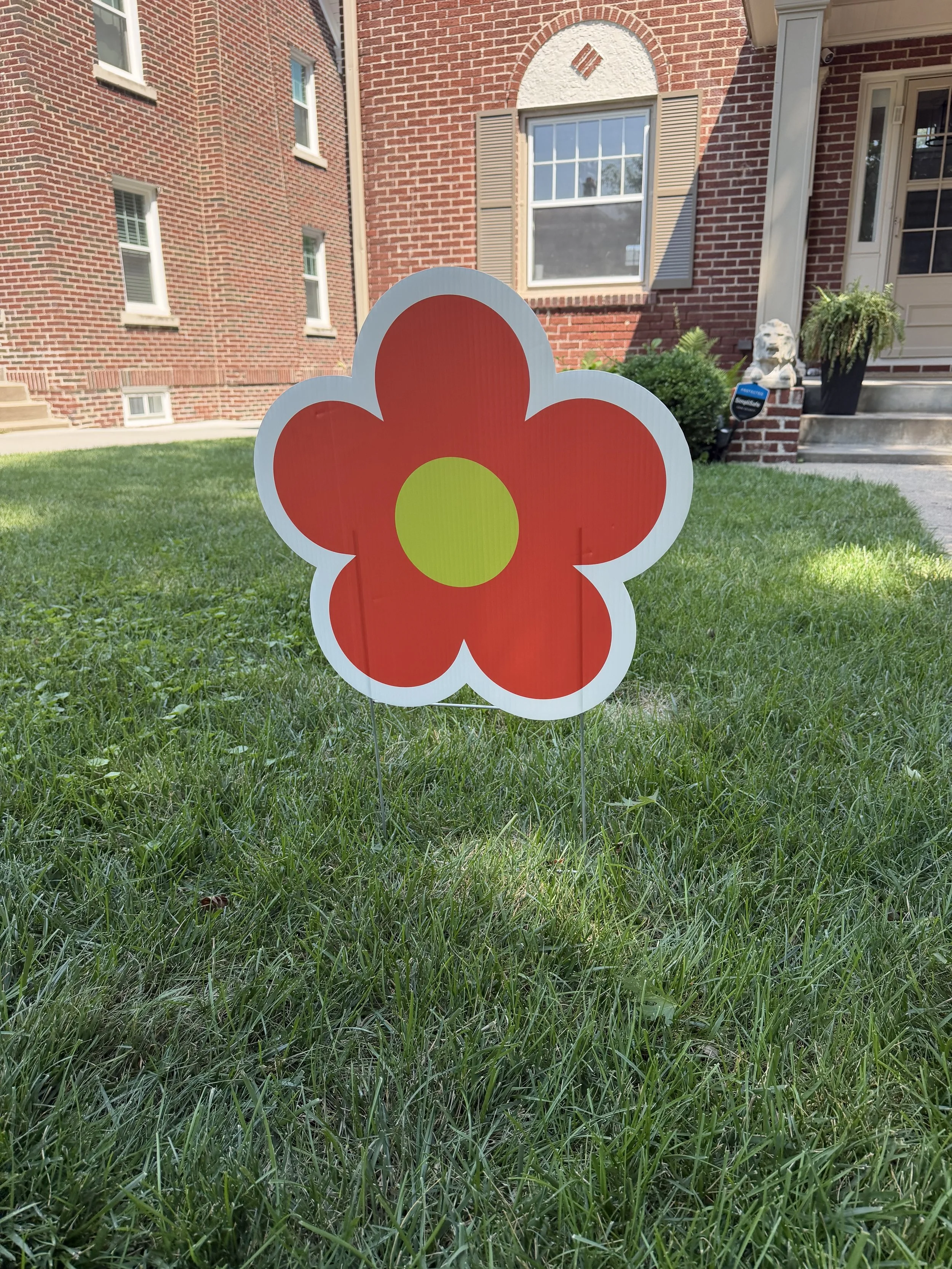 Happy Birthday yard sign with flower accent, installed in Westside, Omaha