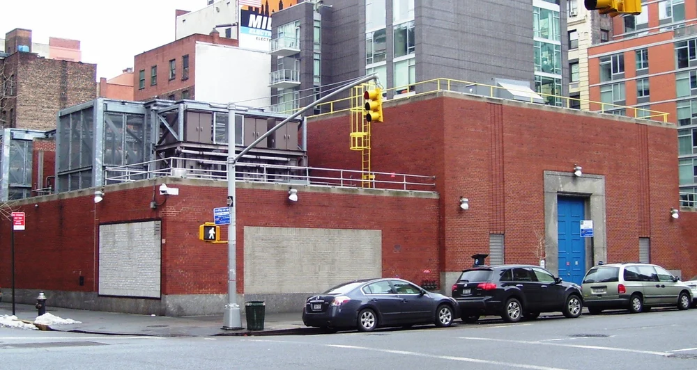 A brick Con Edison substation with electrical equipment above the street at Seventh Avenue and 19th Street, Manhattan.