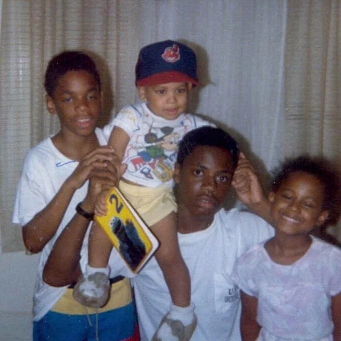 Rashad Houston at his second birthday, on his big brother’s shoulders, with his brothers and sister.