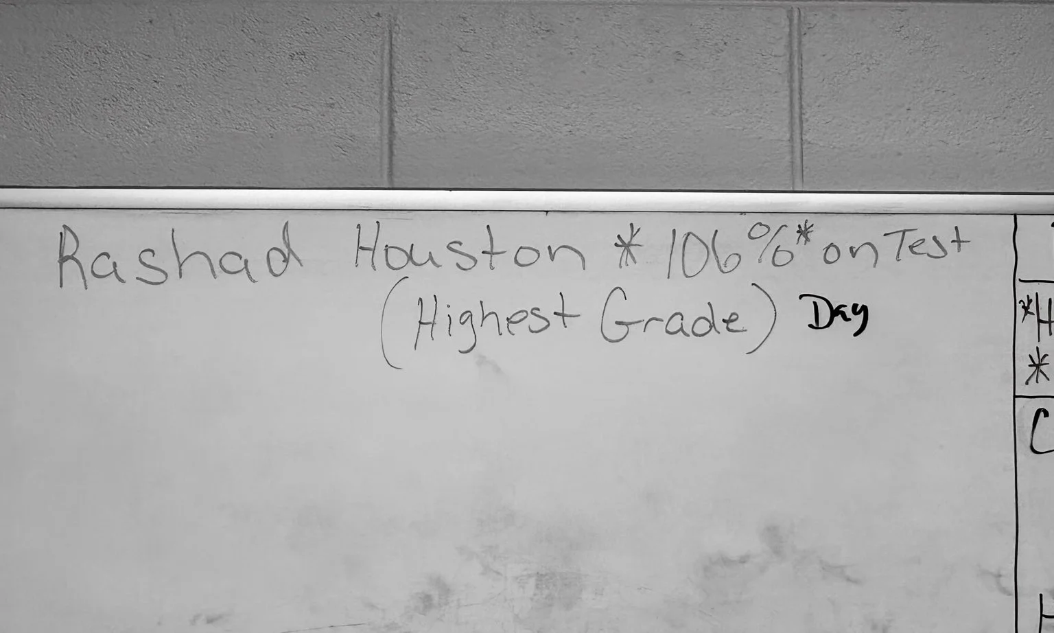Black-and-white whiteboard photograph showing Rashad Houston’s name beside 106% on Test and Highest Grade.