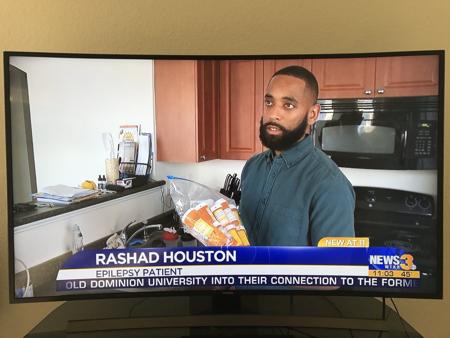 Television screen showing Rashad Houston being interviewed by WTKR in a kitchen.