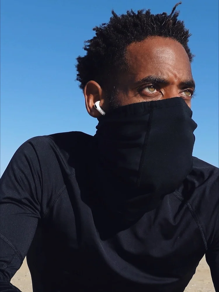 Rashad Houston outdoors during cold-weather training under a blue sky.