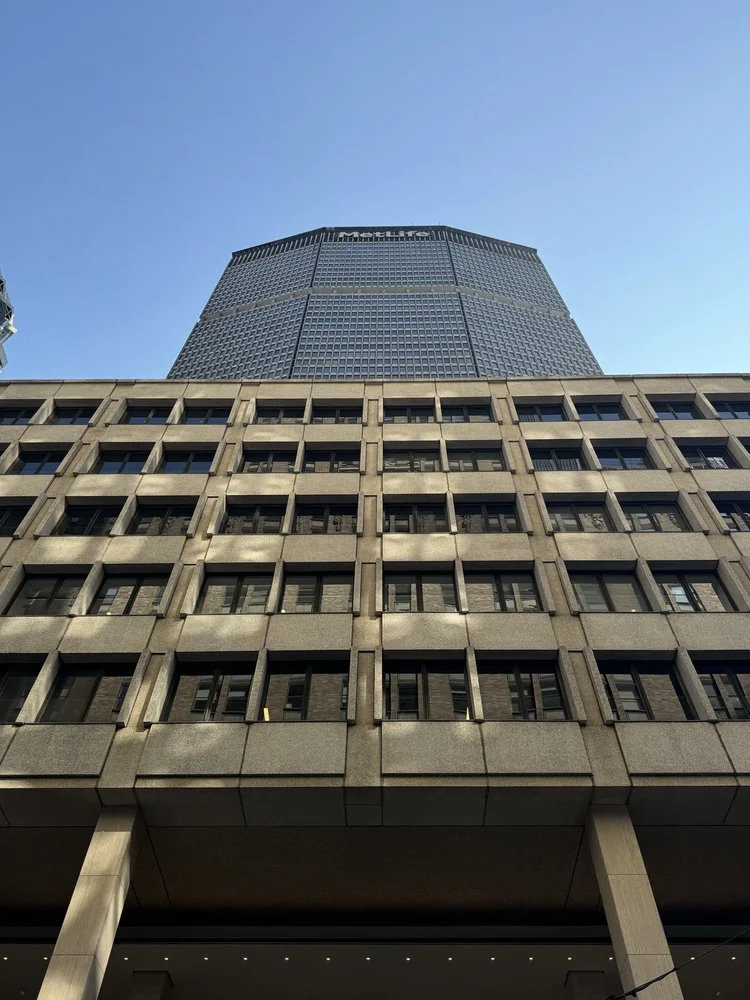 The MetLife Building seen from below against a clear blue sky.