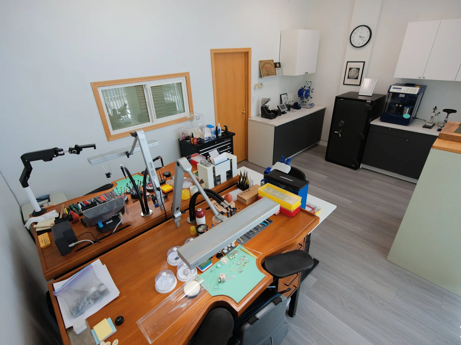 Overview of the Meridian watch repair workshop with workbenches, cabinets and testing equipment