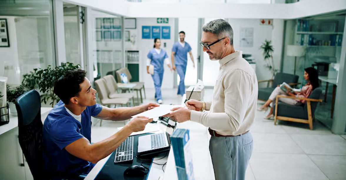 Patient checking in at a medical office reception desk