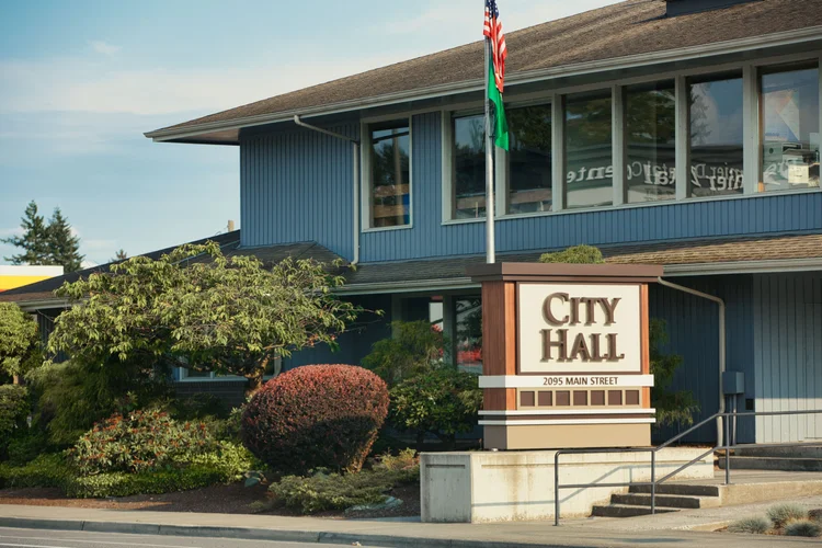 A city hall exterior with entrance signage