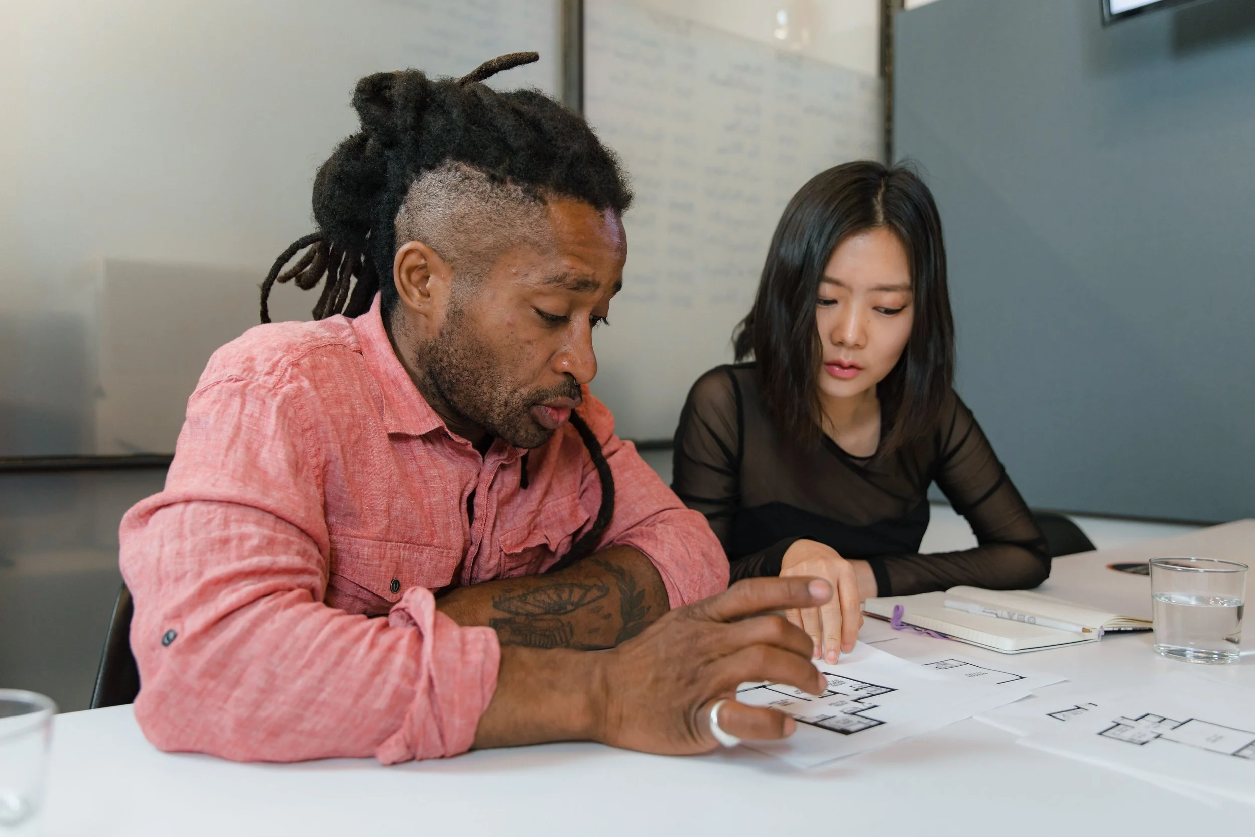 Coworkers reviewing plans together in an office