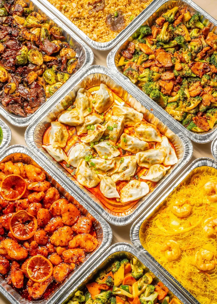 Friends sharing a MÓGŪ catering spread