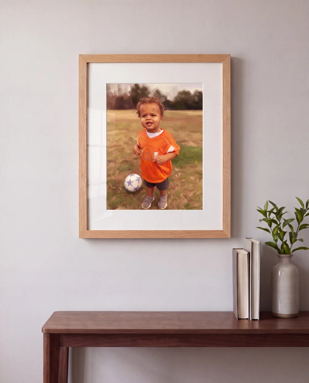 The framed portrait in a natural oak frame with an off-white mat