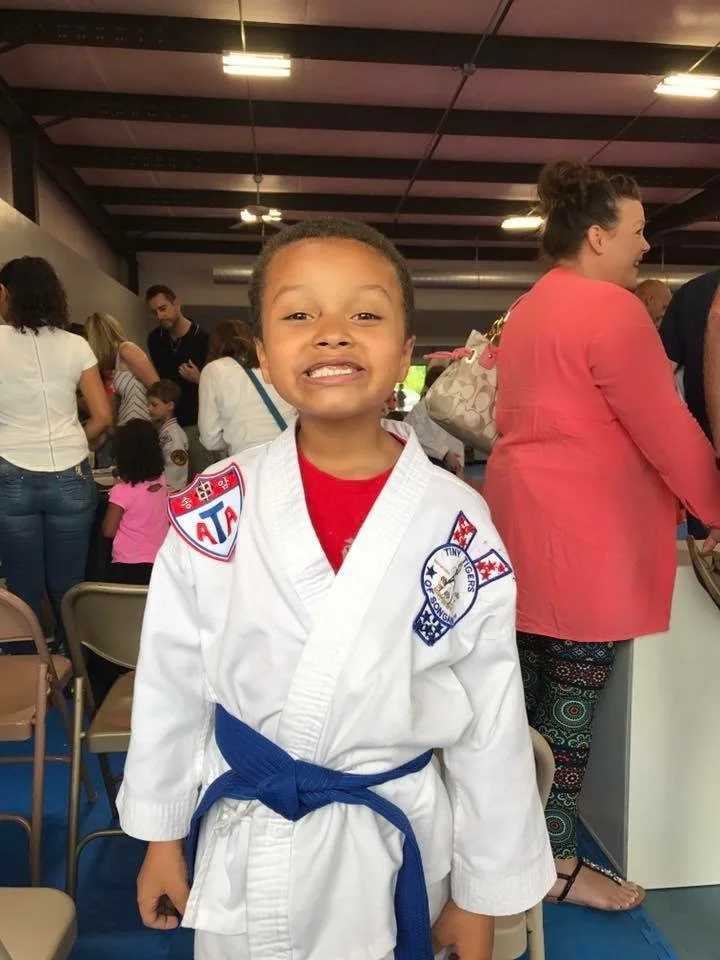 Original phone snap: phone snap of a boy with a new blue belt