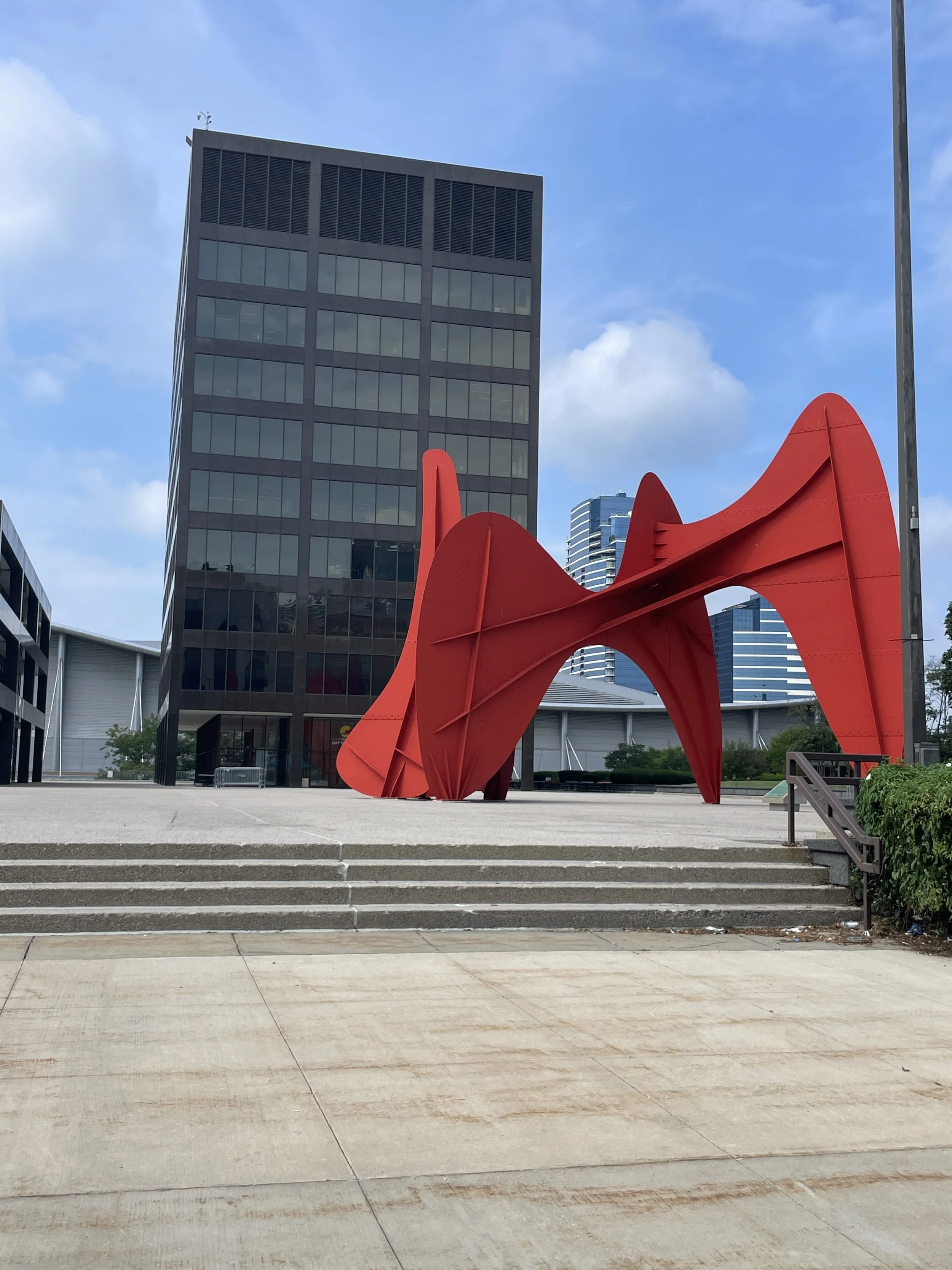 Exterior of Grand Rapids City Hall and the red public sculpture at Calder Plaza.