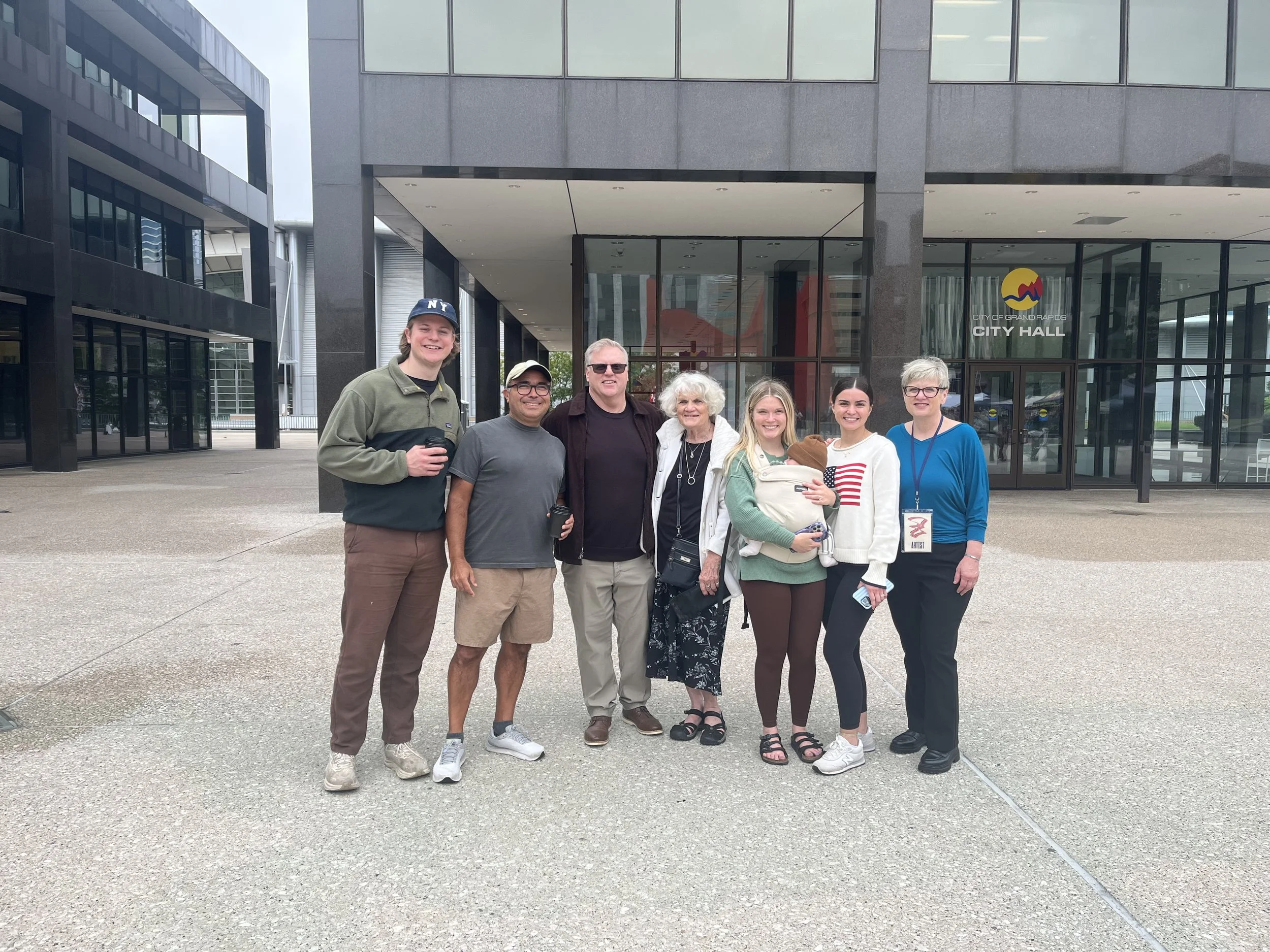 Kelly Lynne Figueiredo with family and supporters outside Grand Rapids City Hall during ArtPrize 2026.
