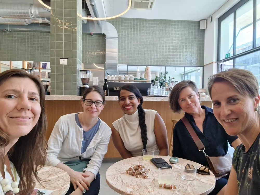 Five members at a café table