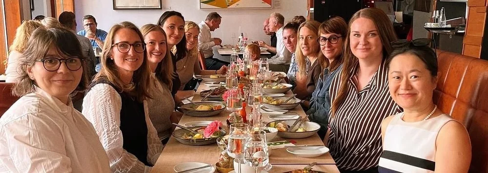 Members around a long lunch table