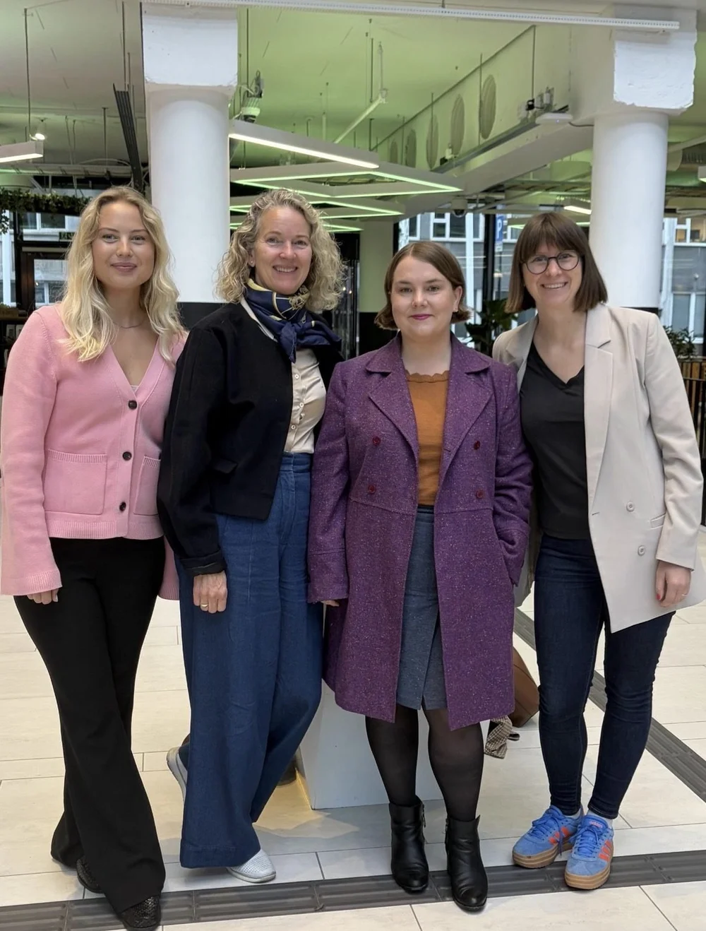 Four members standing together at a meet-up