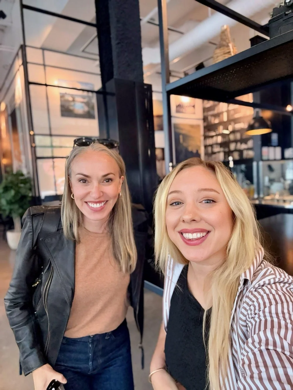 Two members smiling at a café