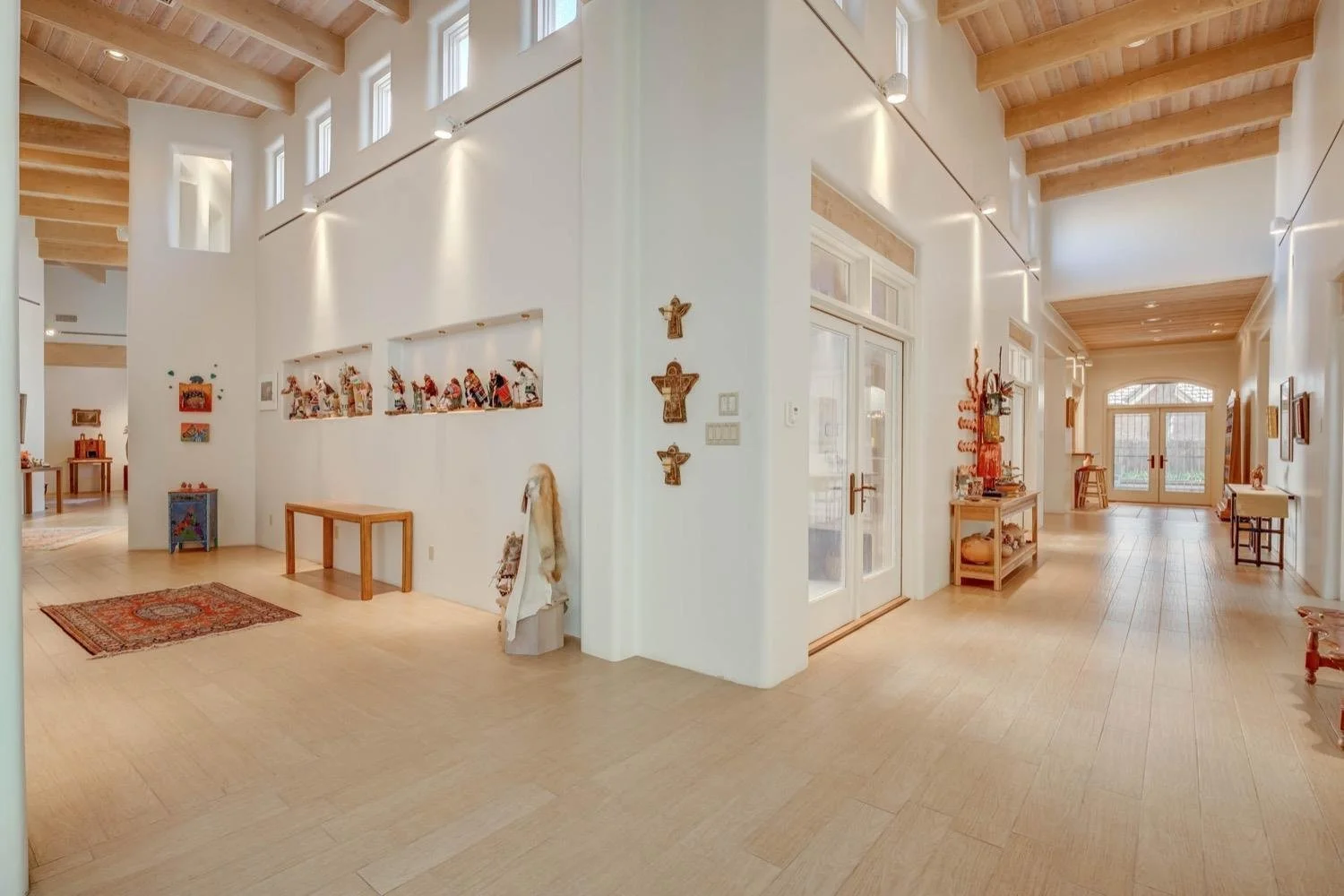 Light-filled entry hall with exposed timber ceilings.