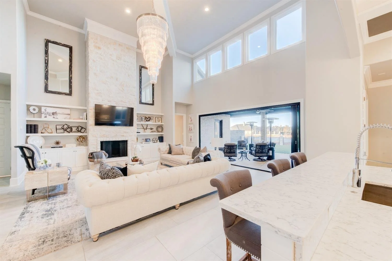Open living room and kitchen overlooking a covered patio.