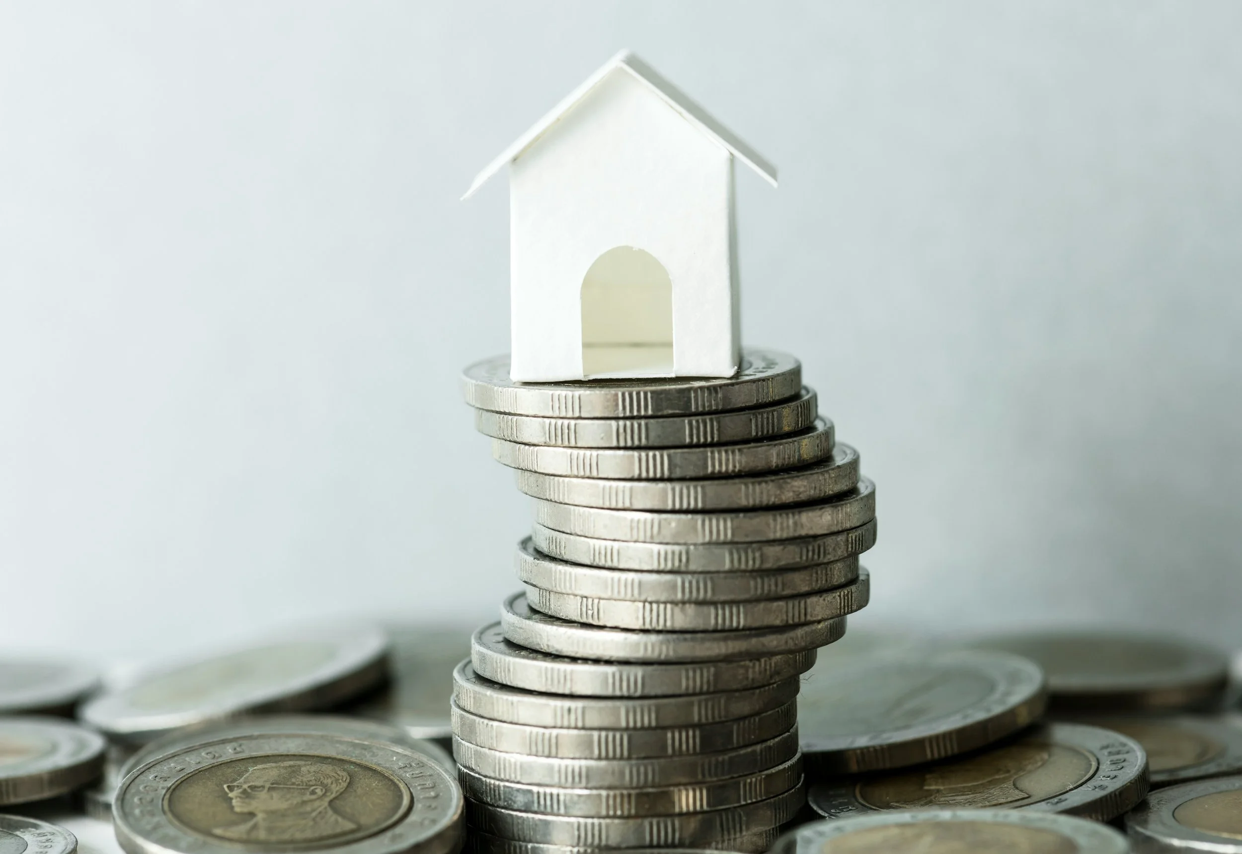 House model and coins representing home equity