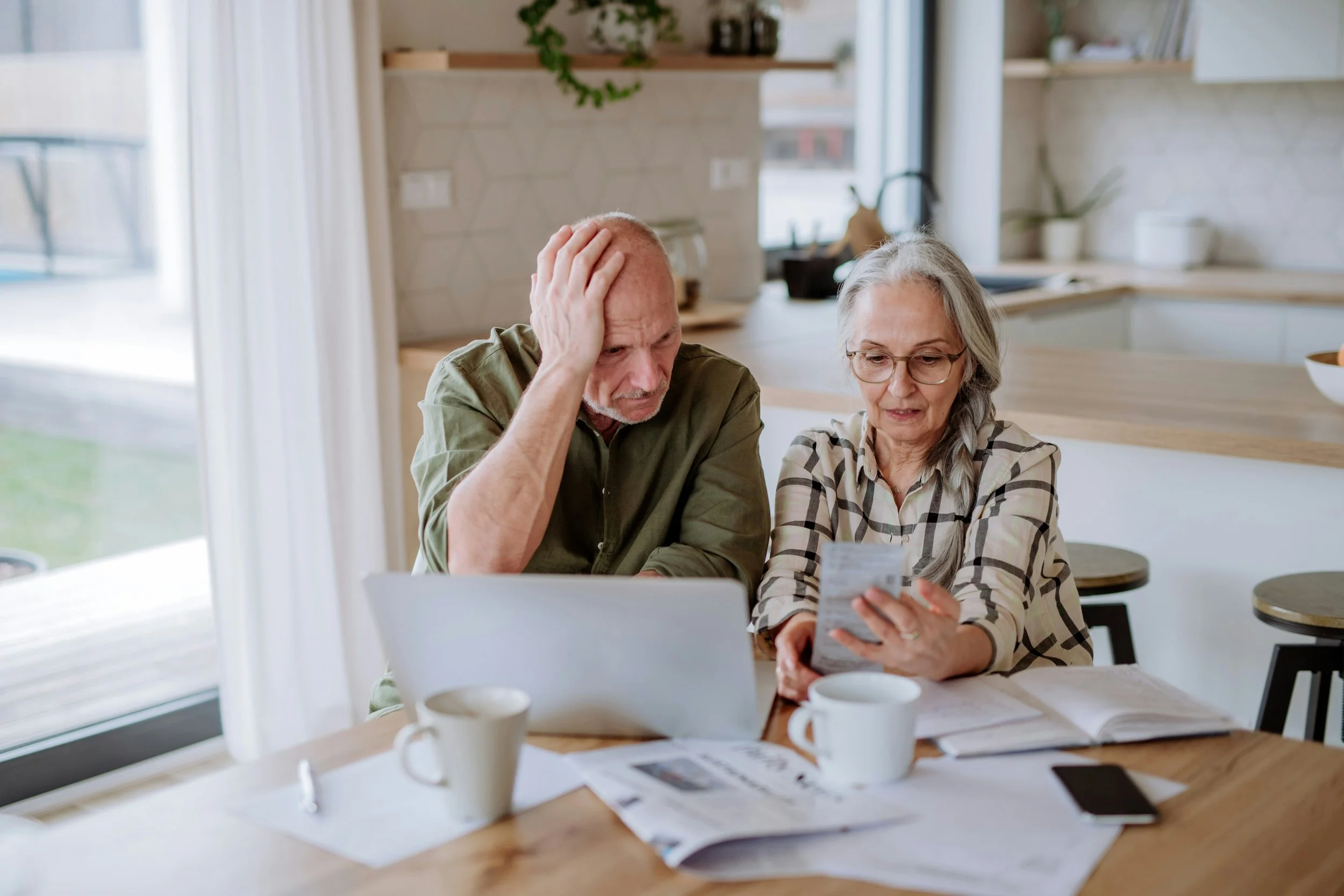 Senior couple reviewing financial documents at a desk