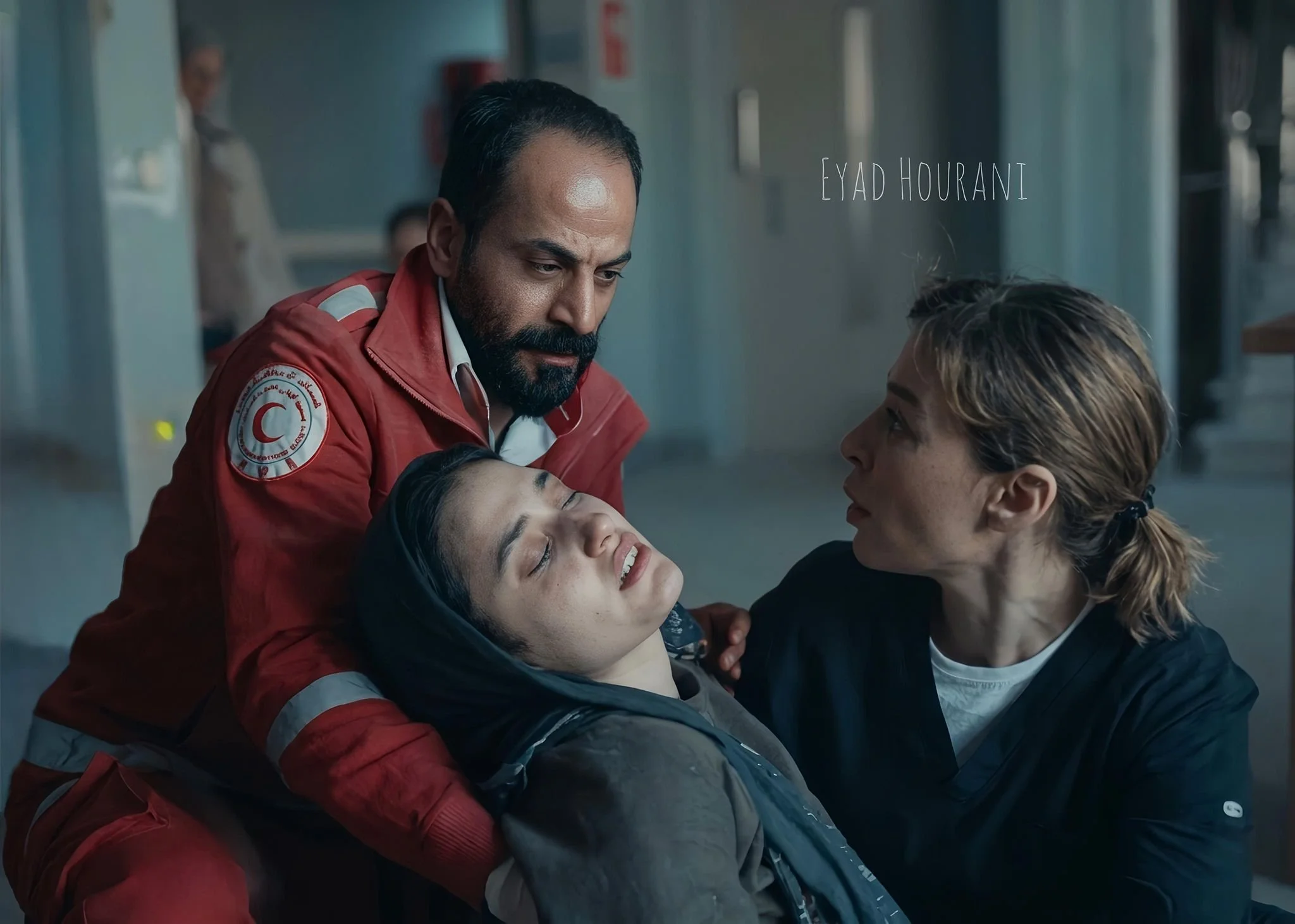 Eyad Hourani in a scene wearing a red paramedic jacket