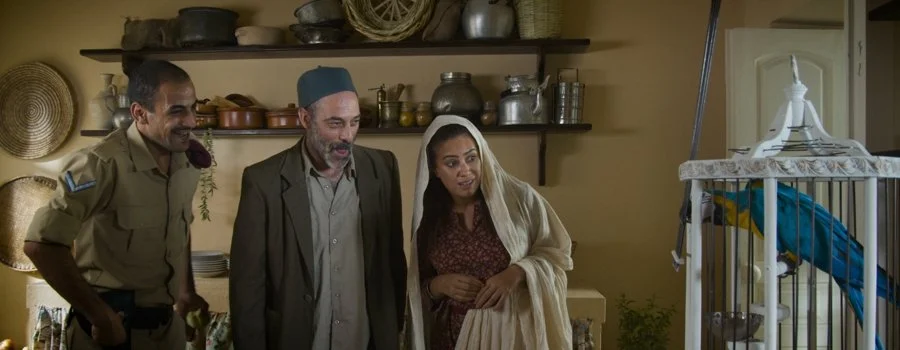 Eyad Hourani in a scene with the cast and parrot — The Parrot
