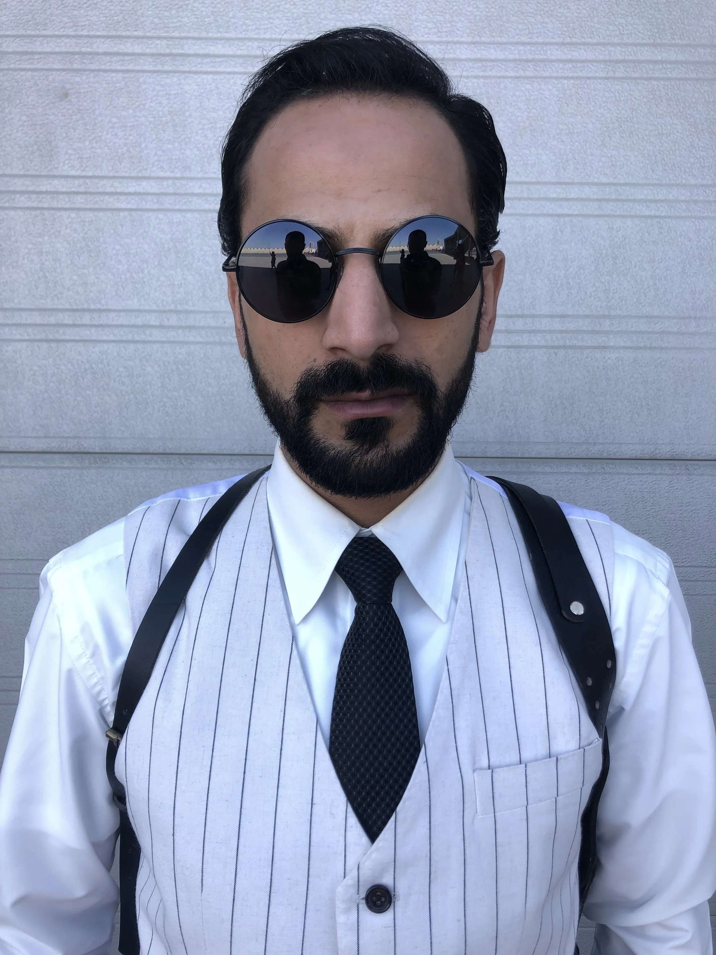 Eyad Hourani in white costume and sunglasses — Vanguard behind the scenes