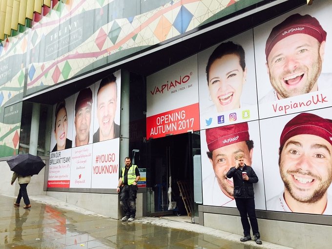 Vapiano staff portraits displayed in a restaurant window — Wayne Lennon