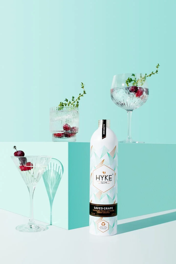 Hyke gin bottle with cocktails on a mint-green studio set