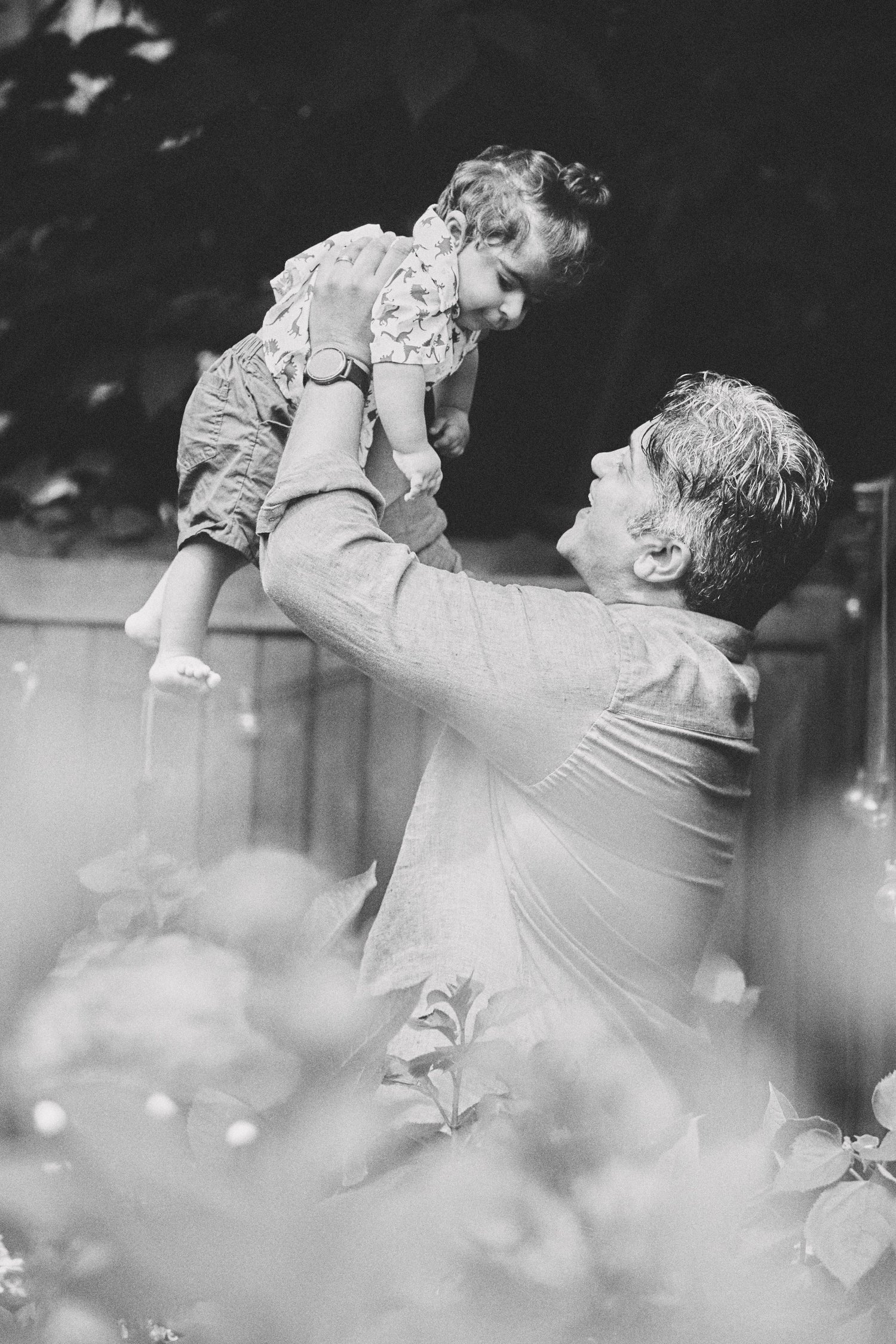 Yuvaan lifted joyfully into the air by his father