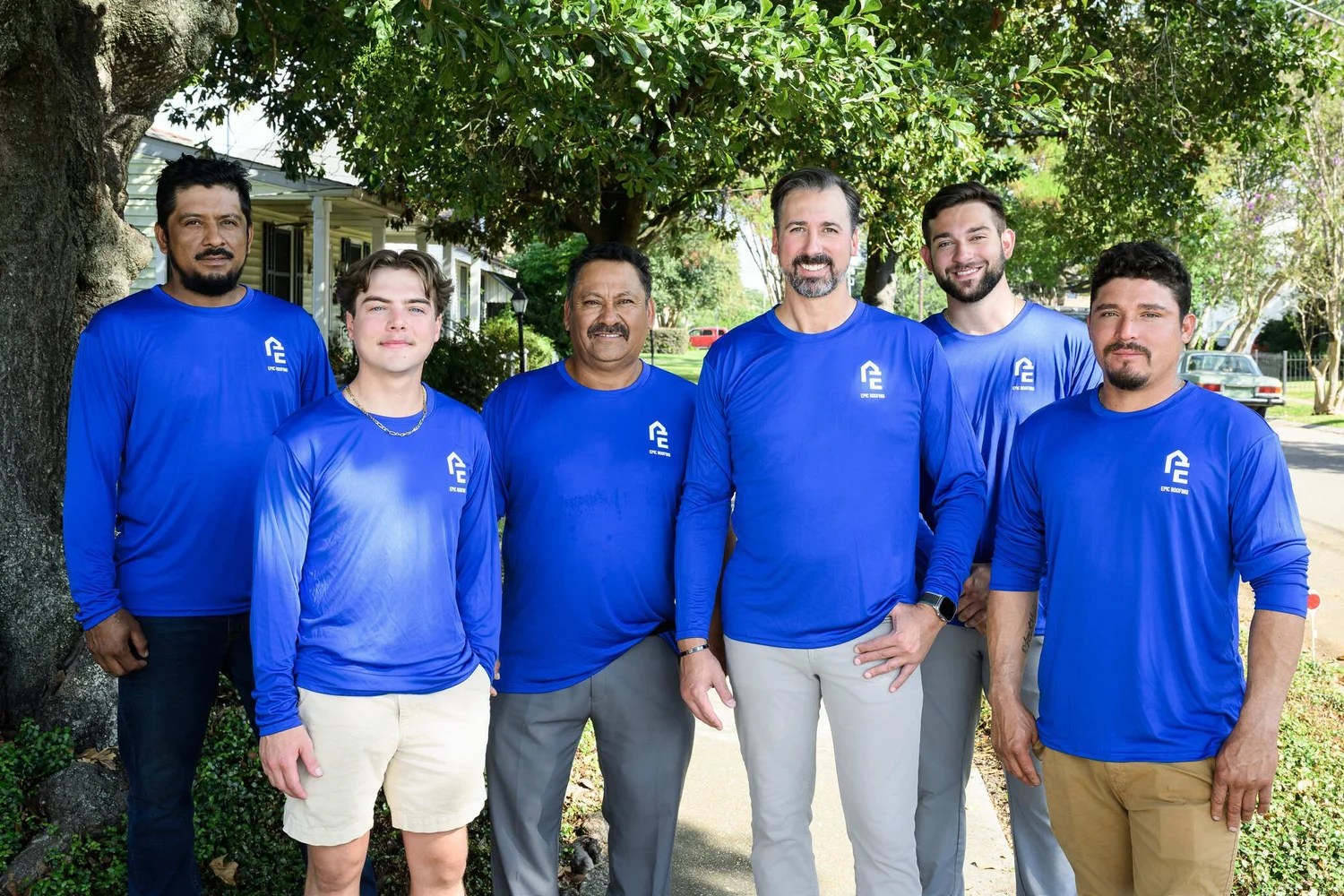 Epic Roofing crew of five standing together outside