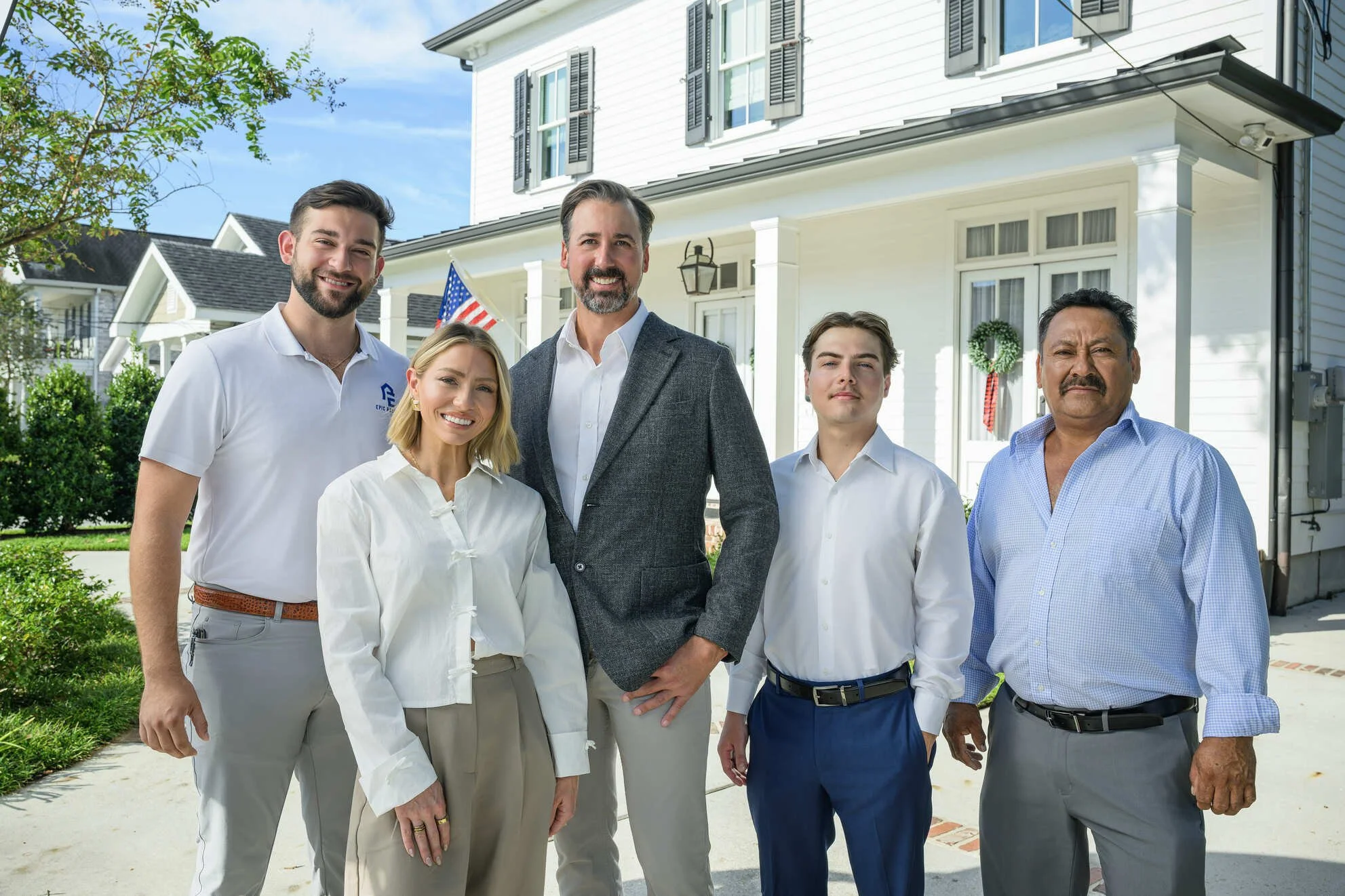 Joey and Gabby Noto with the Epic Roofing team in front of a Mandeville home