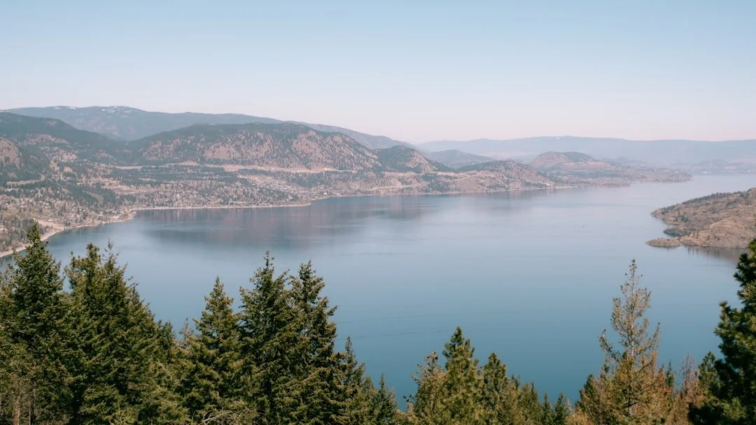 Blue lake water and surrounding Okanagan hills