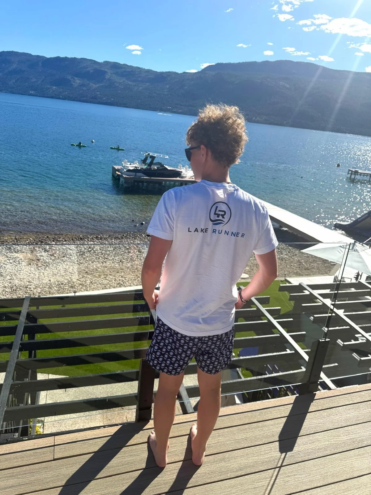 Charlie in a Lake Runner shirt overlooking the lake