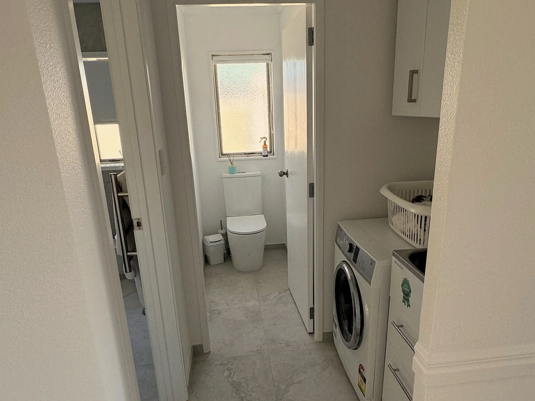 Toilet and laundry after upgrade, Tauranga apartment