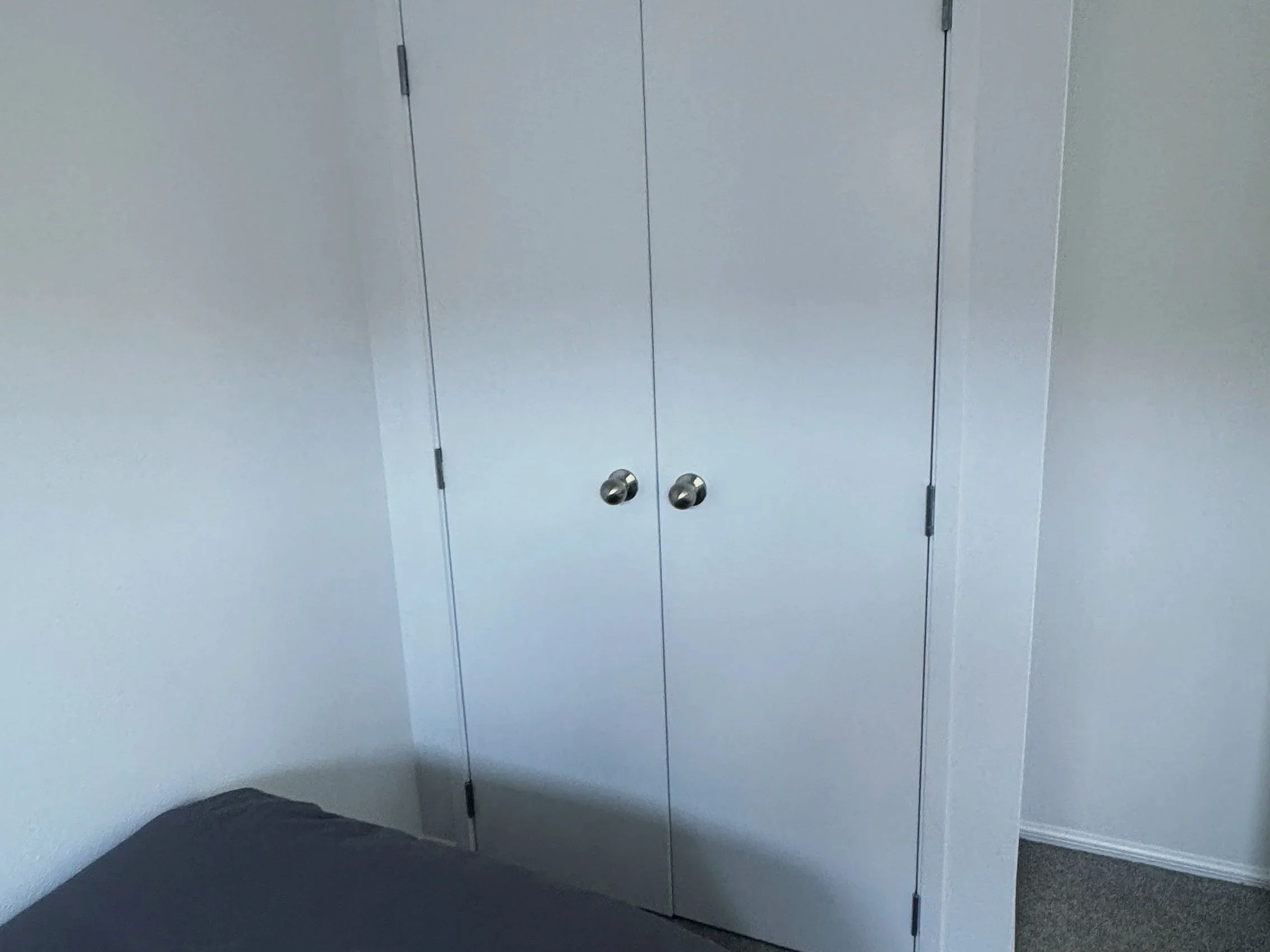 Bedroom wardrobe after double doors installed, Tauranga apartment