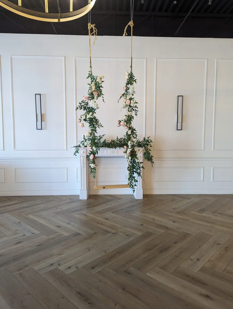 Floral swing wrapped in silk greenery and white blooms