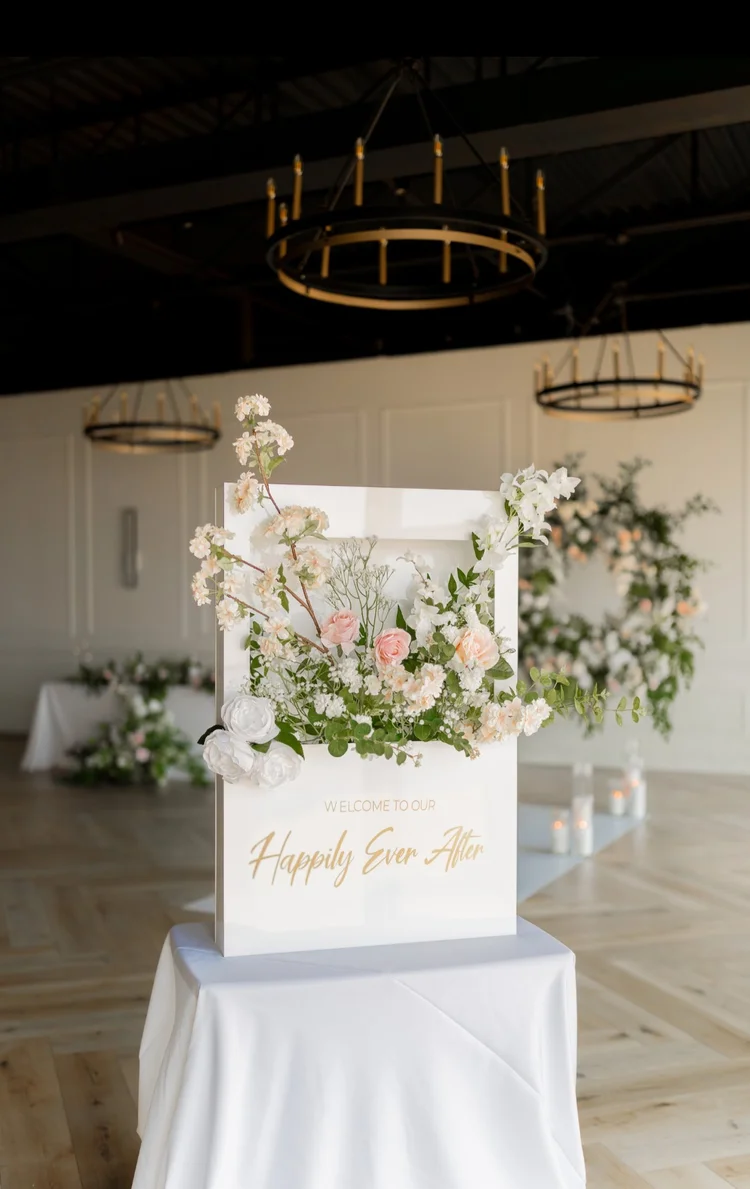 White floral welcome box reading Happily Ever After