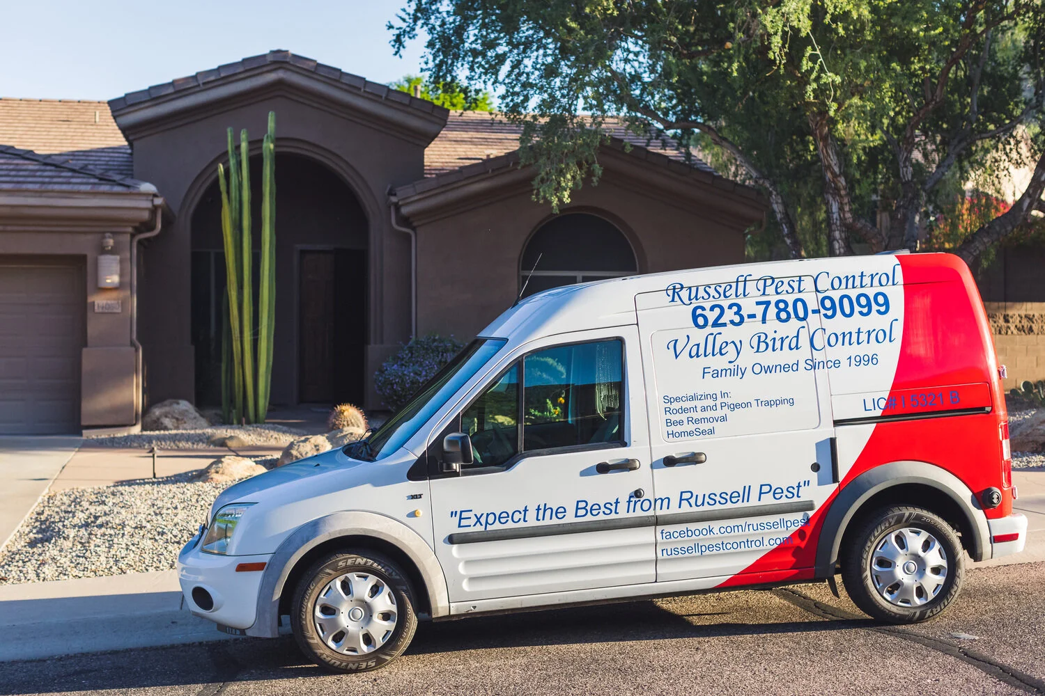 Russell Pest Control technician treating a residential property