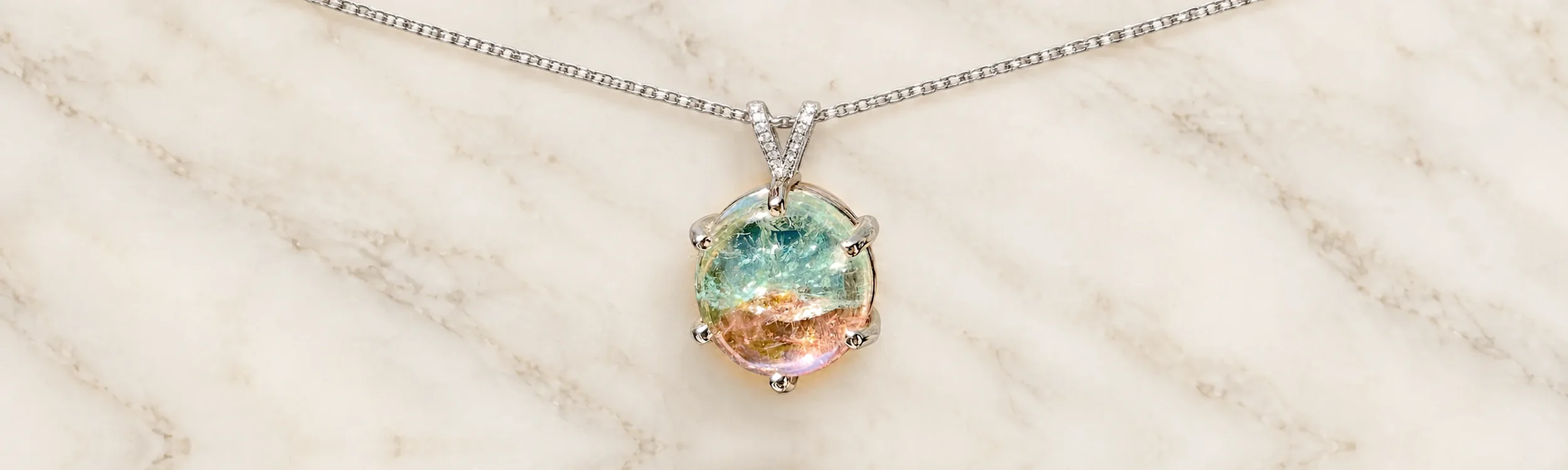 Bicolor watermelon tourmaline pendant in a diamond-accented gold bail, 54 carats