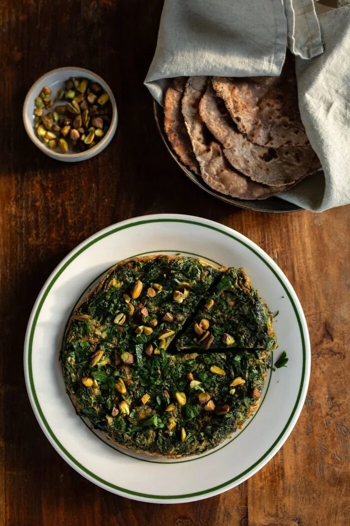 A herb and greens frittata topped with pistachios