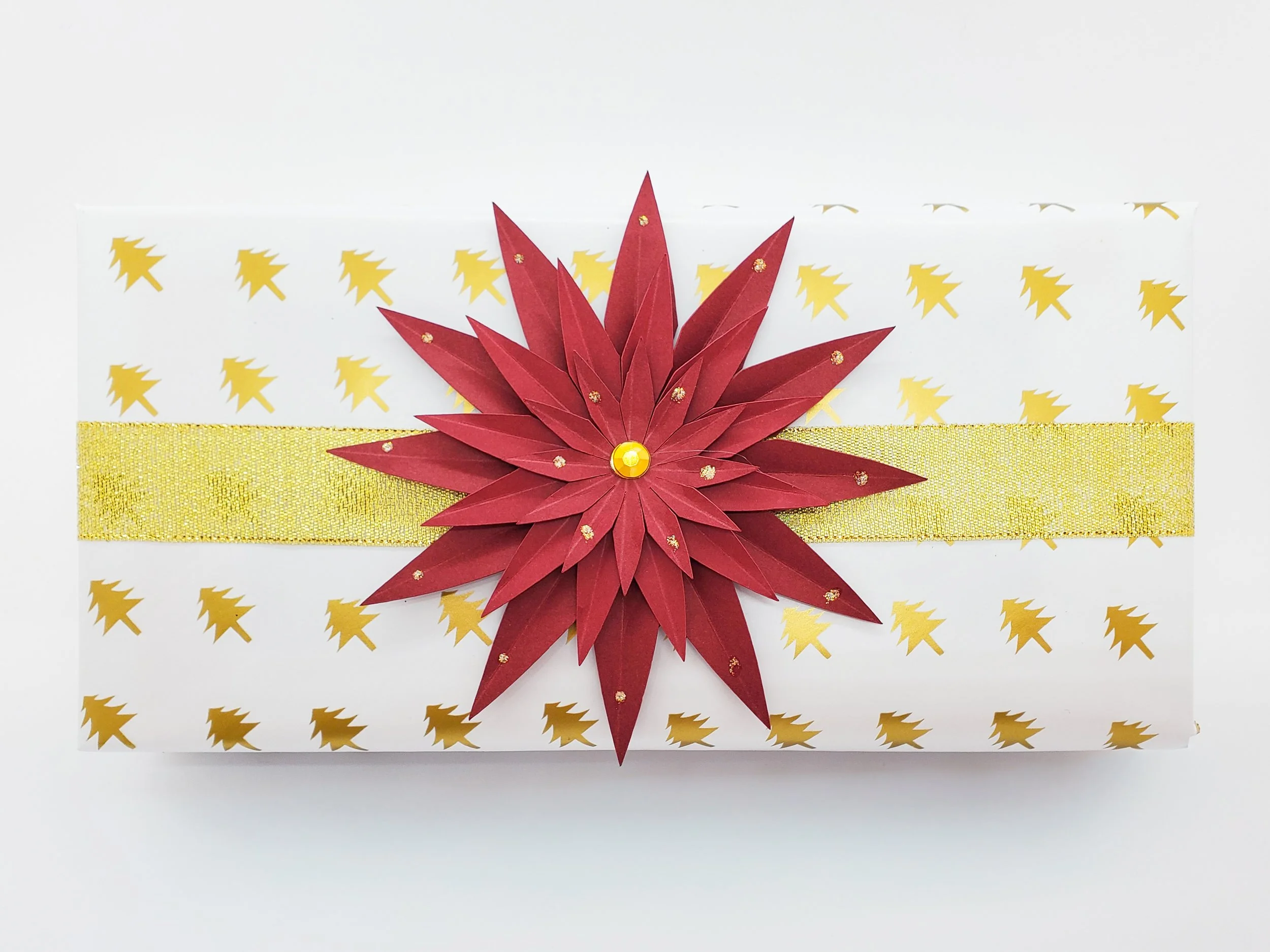 Gift wrapped in gold damask sealed with a wax stamp