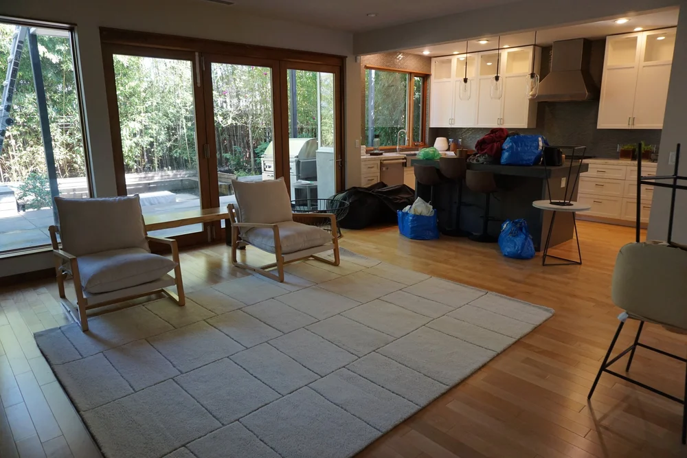 Empty living room with packed moving bags waiting by the kitchen, apartment move in Tigard