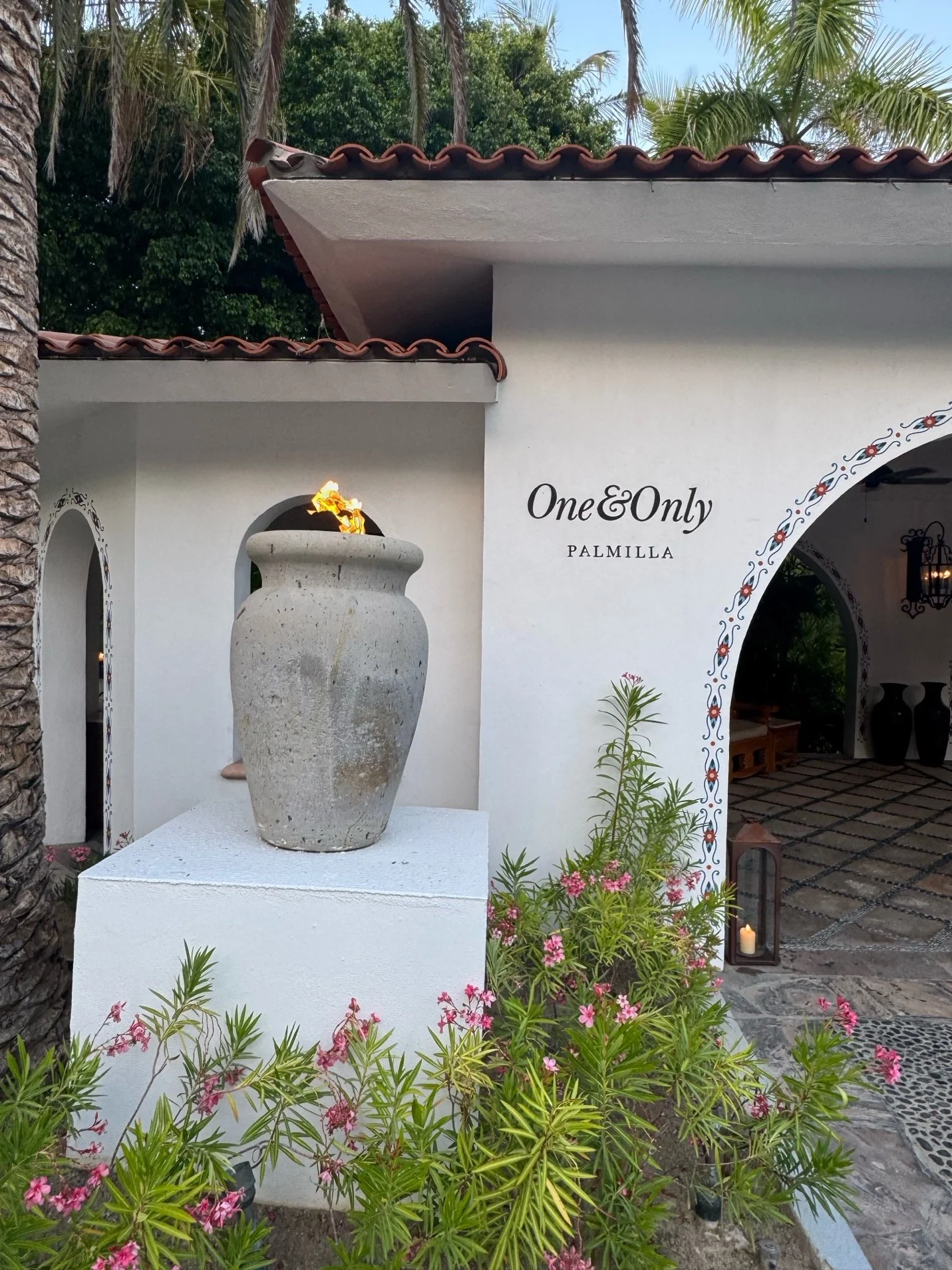 One&Only Palmilla entrance with lit urn and blooming oleander