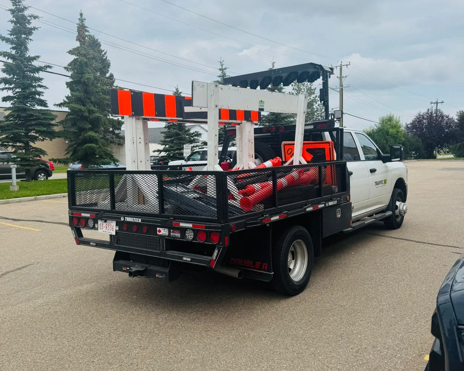 TrafficIQ delivery truck loaded with traffic control equipment heading to a job site