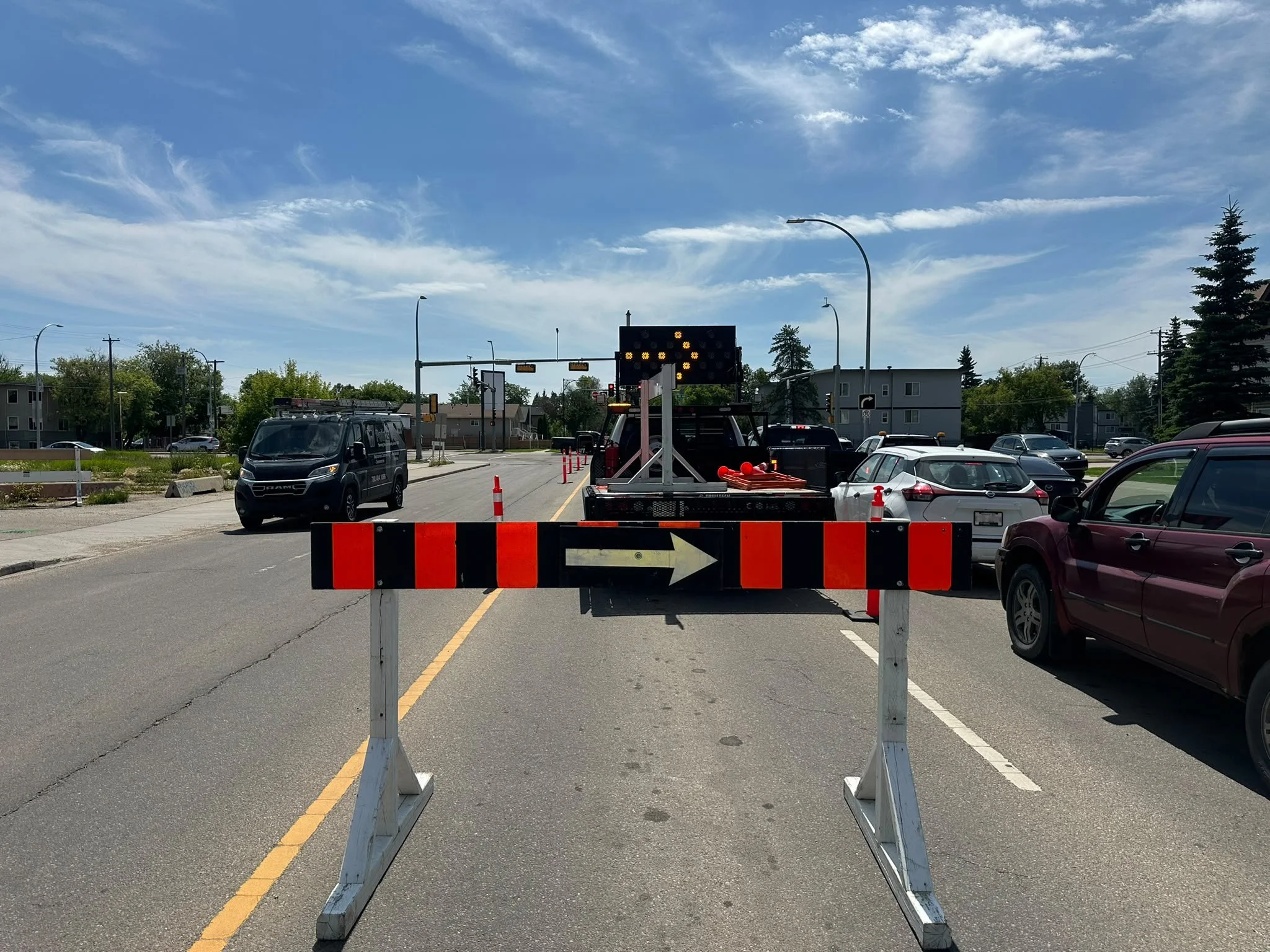 Stop/slow paddle sign held by a certified traffic control person at a work zone